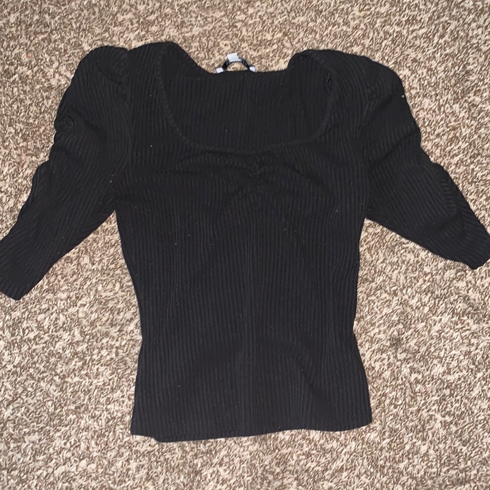 Black rib knit top. Quarter sleeve with puffy shoulders